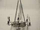 a chandelier hanging from the ceiling with a bird on it
