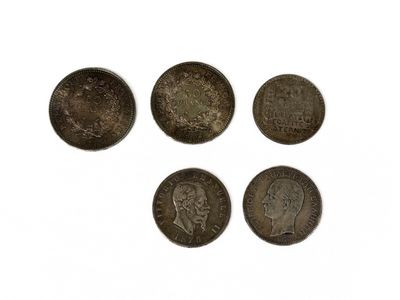 four different types of coins are shown on a white surface