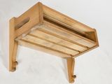 a wooden shelf with a magazine rack attached to it