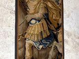 a wall hanging with a picture of a man on a horse