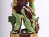 a statue of a woman sitting on top of a box