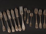 a lot of forks and spoons sitting on a table