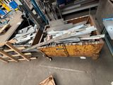 many pieces of metal sitting on the floor in a warehouse