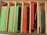 a wooden box filled with assorted colored papers