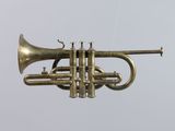 a brass trumpet that is hanging from the ceiling