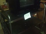 a microwave sitting on a cart in a kitchen