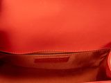a close up of the inside of a red handbag