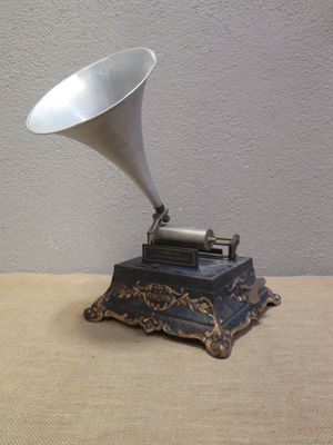 a silver and black gramphone sitting on a table