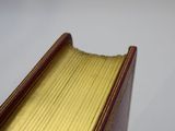 a close up of a book with a gold cover