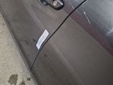 a close up of a car door handle with a sticker on it