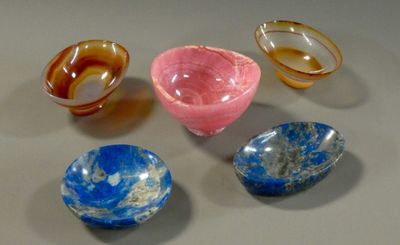 five different types of glass bowls on a table