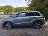 a picture of a silver suv parked in a parking lot