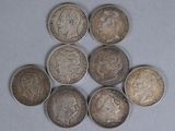 six different types of coins are arranged in a triangle