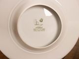 a white plate with a picture on it on a table