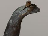 a statue of a bird with a snail on it ' s head