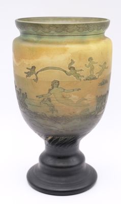 a yellow vase with a black base on a white background