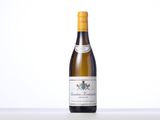 a bottle of white wine sitting on top of a table