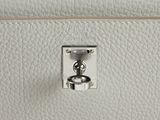 a close up of a white purse with a metal clasp