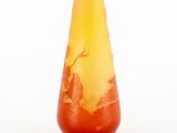 a glass vase with a red and yellow design on it