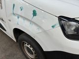 a white van with blue paint on the side of it