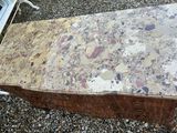 an old suitcase sitting on a gravel ground