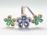 a close up of a pair of earrings with green and blue stones