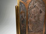 sculpture of a man holding a child on a wooden stand