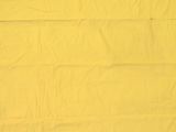a cat that is laying down on a yellow blanket