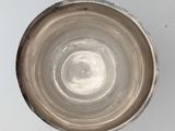 a silver cup that is sitting on a table