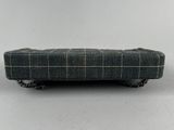 grey and white checkered bench with chain handles