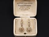 an image of a pair of earrings in a box on a table
