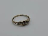 a close up of a gold ring on a white surface