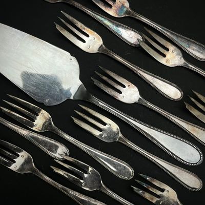 beaucoup de fourchettes et de cuillères sur une table noire
