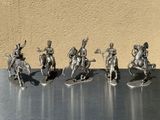 five figurines of men riding on horses on a table