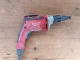 a drill that is sitting on a wooden table