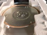 a glass plate with a metal lid in a box