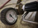 a close up of a pressure gauge and a hose