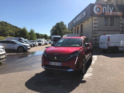 a red car parked in front of a building in a parking lot