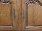 a wooden cabinet with a mirror on top of it