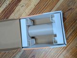 a cardboard box with a roll of tape in it on a wooden floor