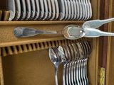 many forks and spoons in a case on the table