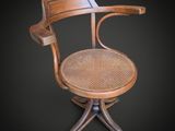 an image of a wooden chair with a wicker seat on a black background