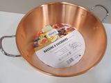 a large copper pan with a handle on a table
