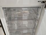an open refrigerator that is sitting on a pallet