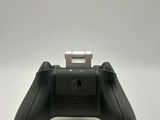 a close up of a game controller on a white surface