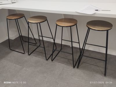 three stools that are sitting in front of a counter