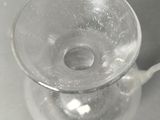 a clear glass cup with a handle on a table