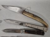 several different types of knives are lined up on a table