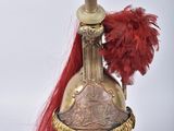 an image of a helmet with a red feather on top of it