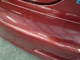 a close up of a red car with a blue sticker on it